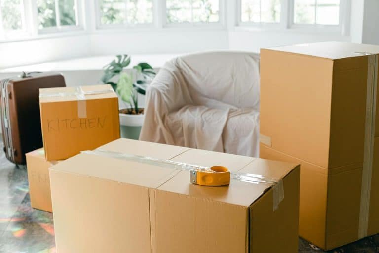 Family unpacking moving boxes in their new home