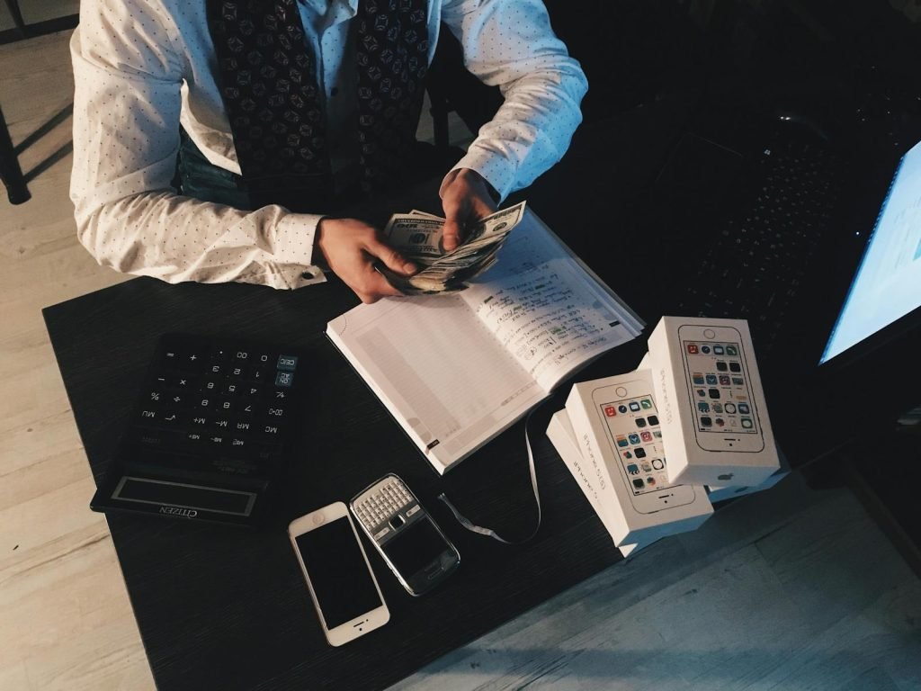Calculator on financial documents representing currency planning for an international move